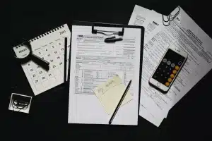 Tax documents and calculator on desk with December 2026 calendar marking the Opportunity Zone deferral deadline