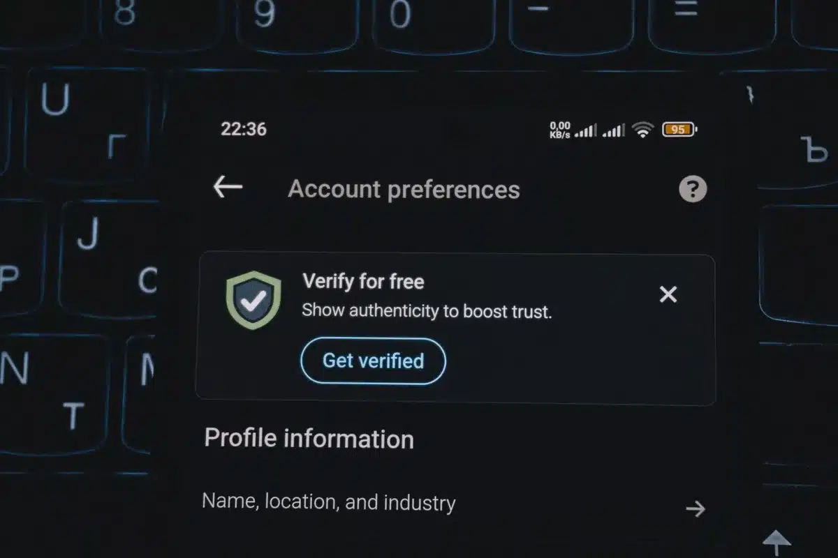 Hands holding a phone in dim light, showing a private message conversation.