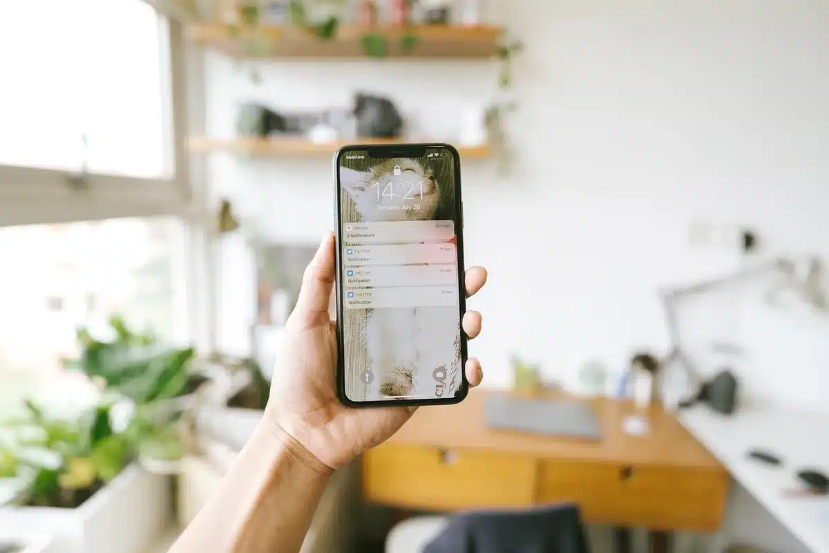 Someone receiving a text message or notification on their phone, representing consistent check-ins.