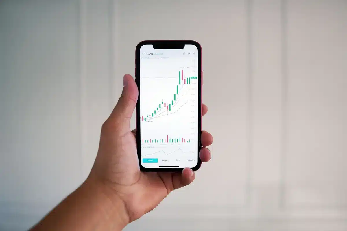 Investor reviewing underwater portfolio positions on computer screen with downward trend indicators