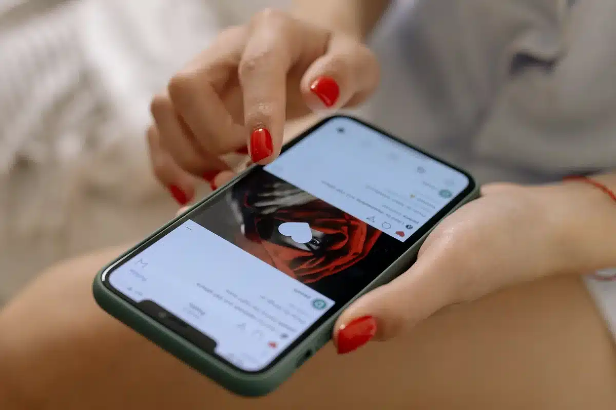 Person scrolling through dating app on smartphone, representing how technology amplifies impulsive dating choices.