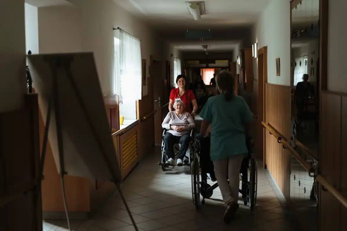 Caregiver assisting an elderly person, illustrating long-term care services