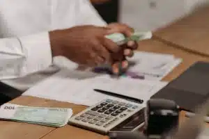 Mortgage documents and calculator on desk showing rising interest rates impact