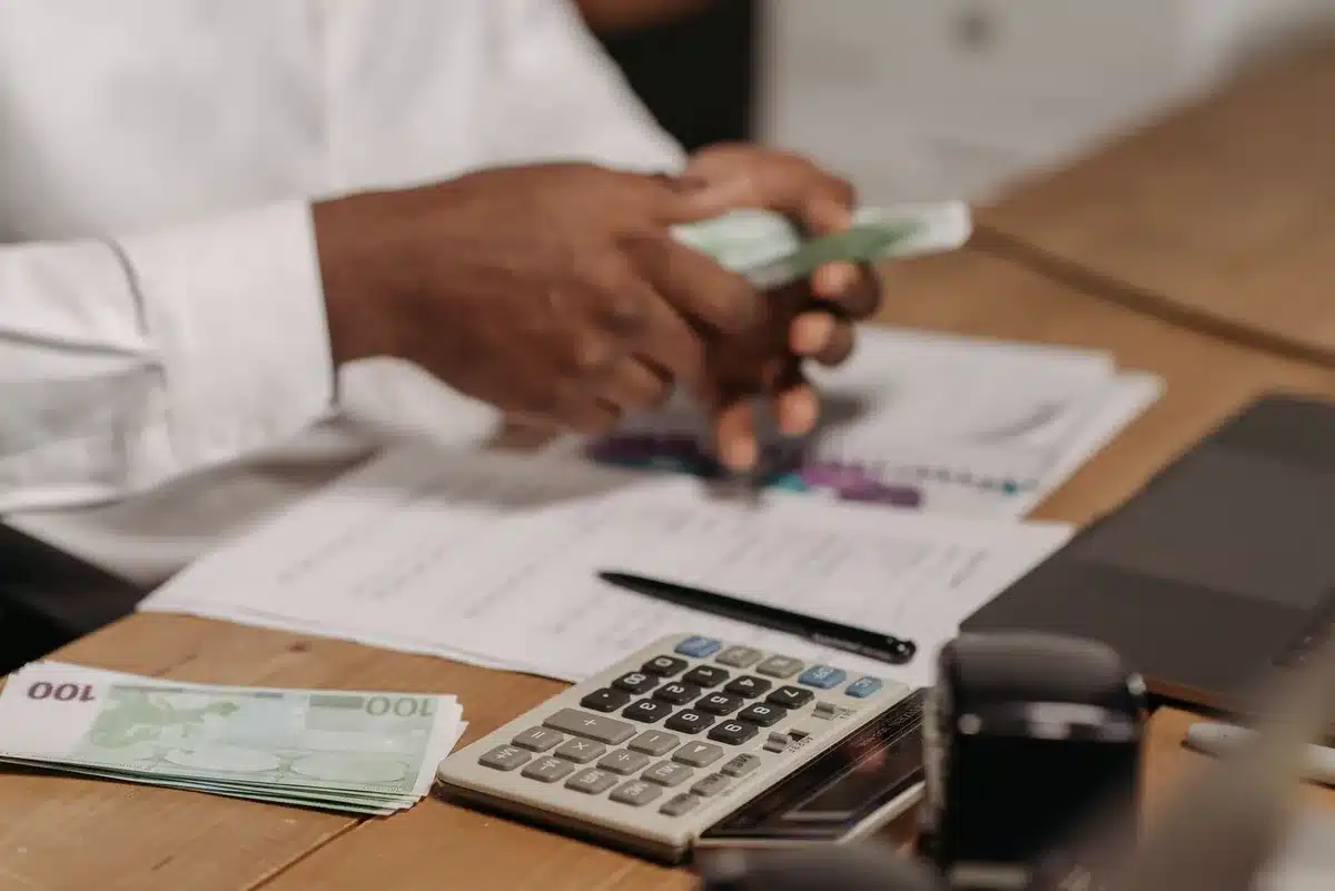 Mortgage documents and calculator on desk showing rising interest rates impact