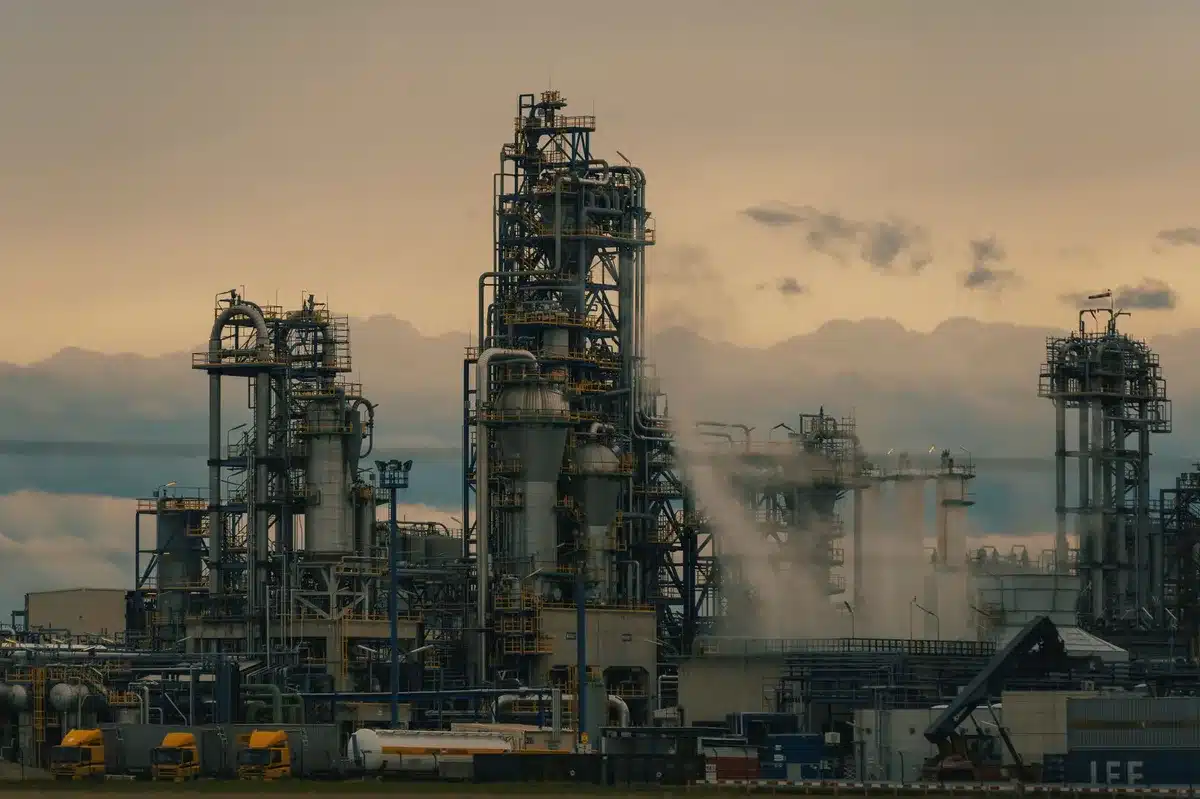 Industrial oil refinery complex with pipes and processing equipment