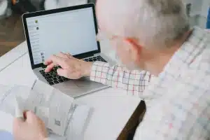 Retiree reviewing retirement income plans and financial calculations at a desk
