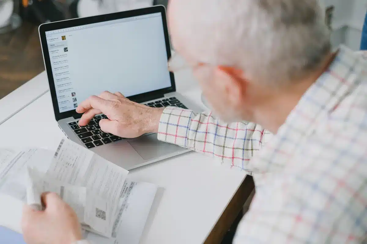 Retiree reviewing retirement income plans and financial calculations at a desk