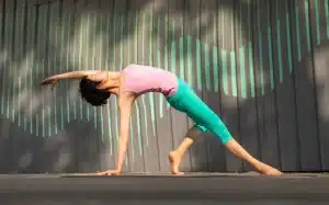 Person practicing yoga or stretching in a bright, calm studio space