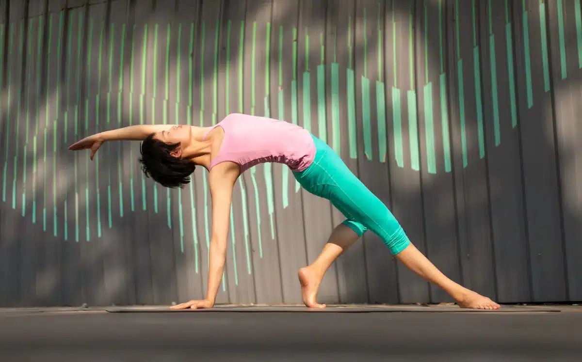 Person practicing yoga or stretching in a bright, calm studio space