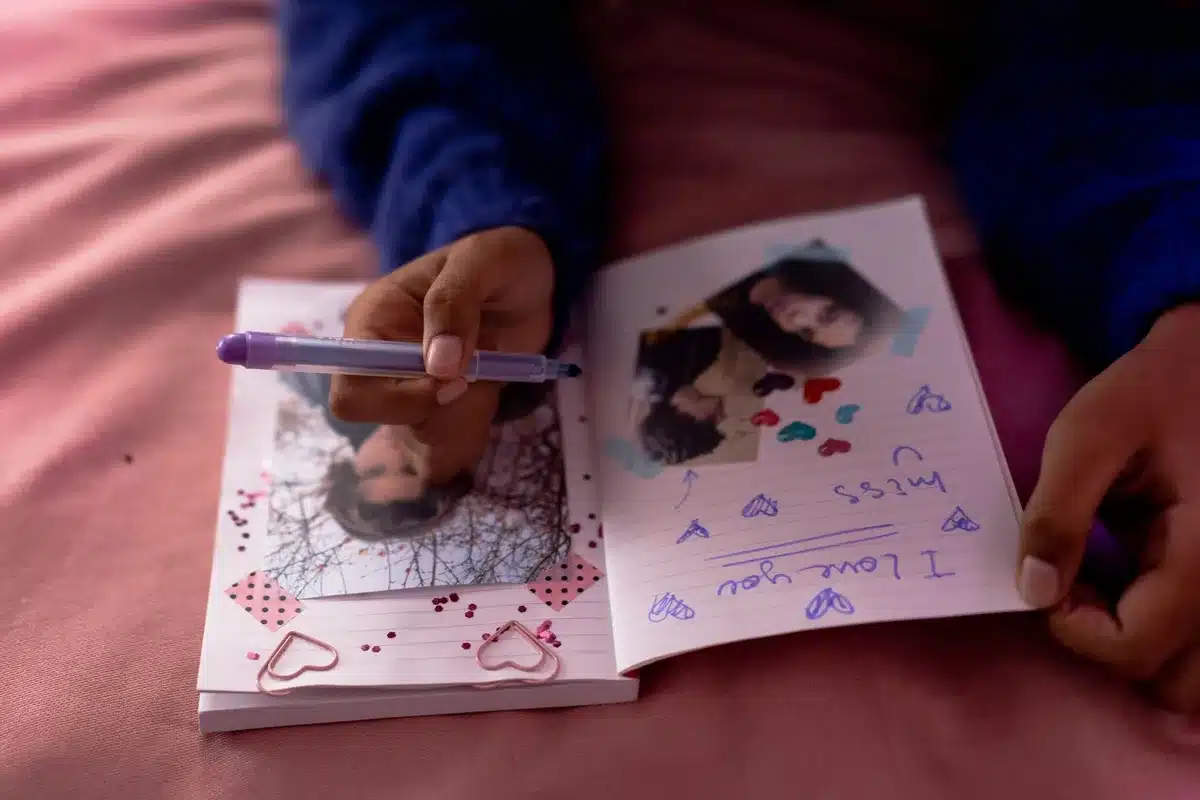 Someone writing in a journal to process and label their emotions.