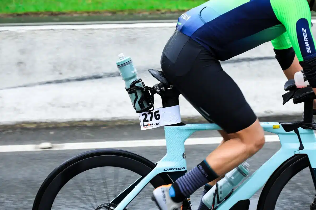Cyclist adjusting cooling socks and jersey during race preparation