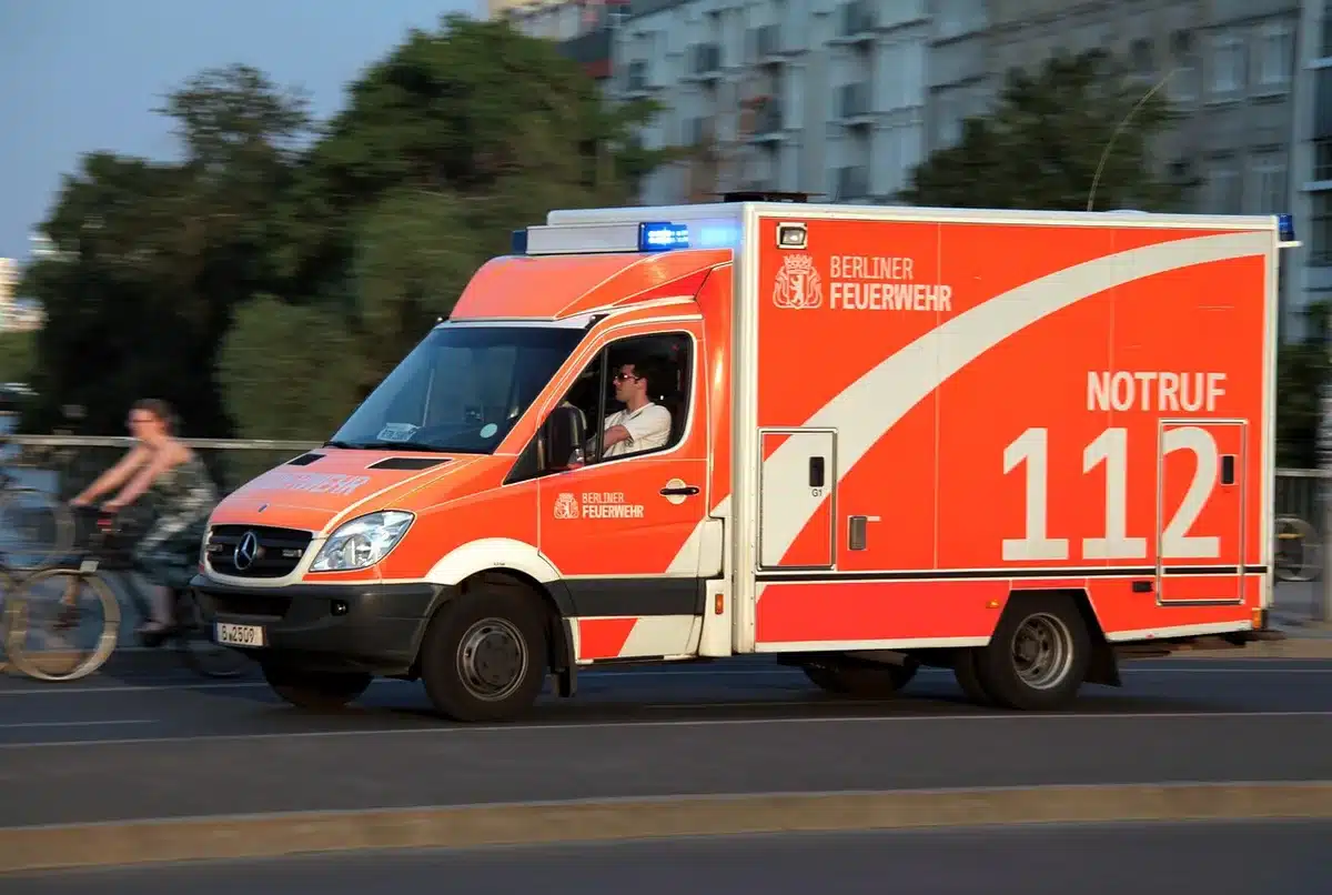 Ambulance lights outside a campus building at night