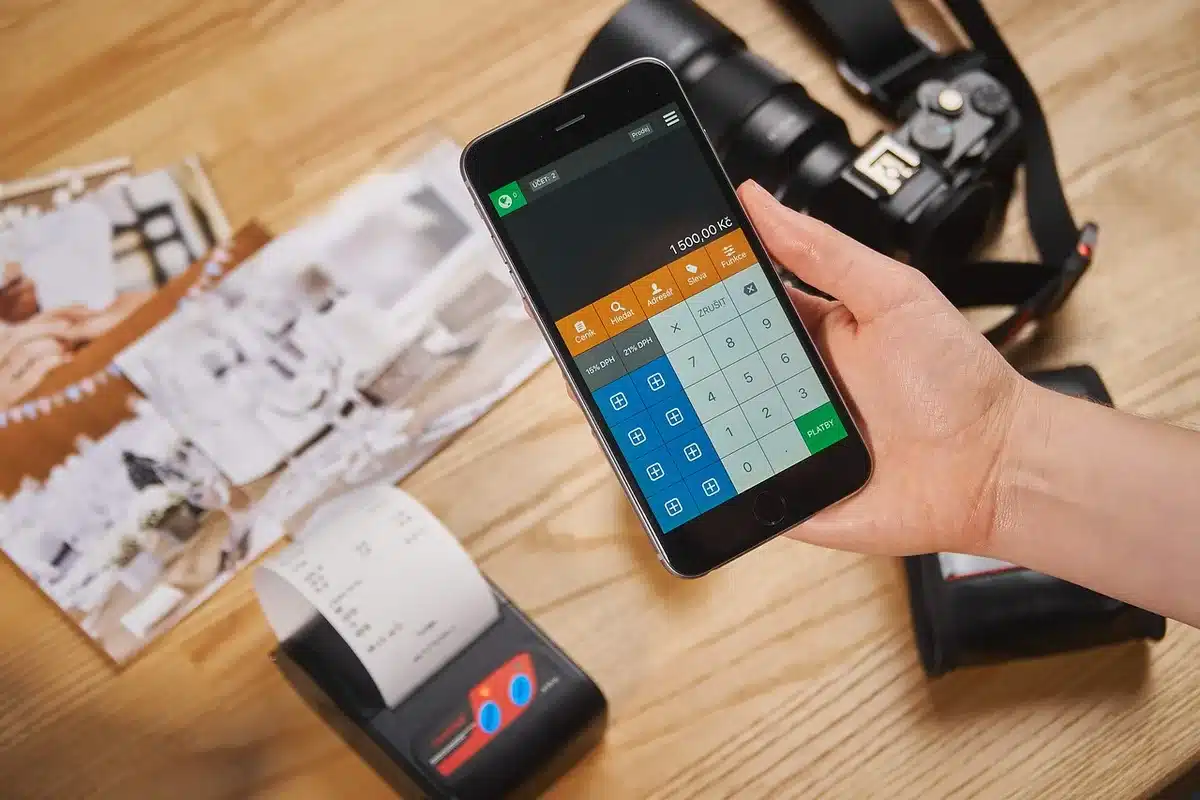 Shopper at checkout counter with groceries and payment terminal, representing BNPL use for essentials