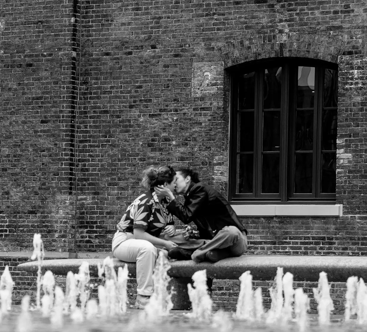 Silhouette of two people sharing a brief intimate moment, implying a single lapse