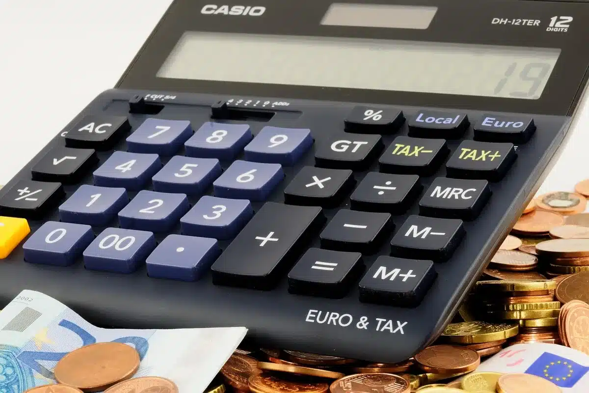 Child's piggy bank with stacked coins and enrollment paperwork