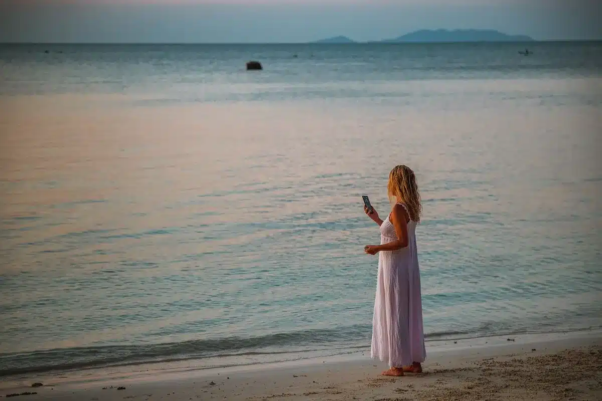 Person at a wedding on a video call instead of socializing