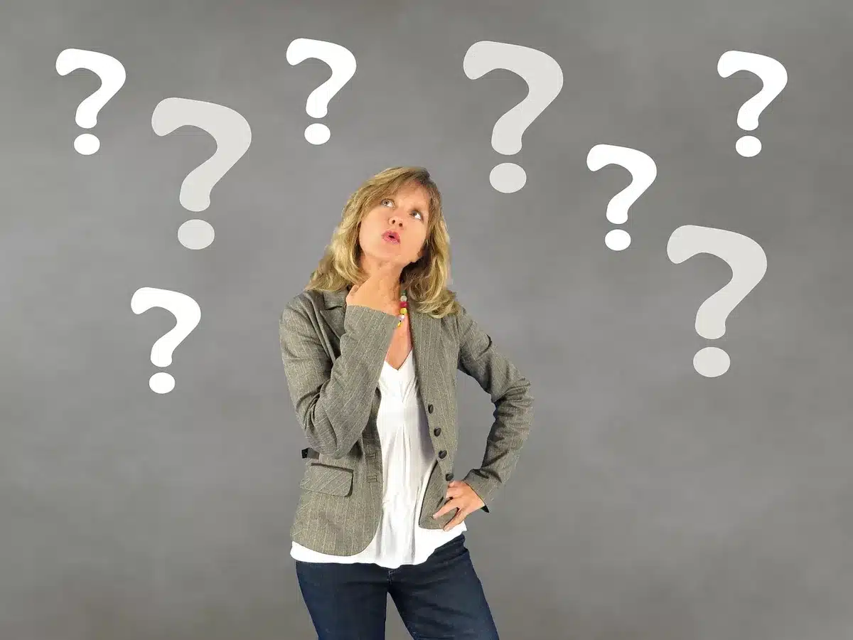 Person looking confused, holding their head as if doubting memory