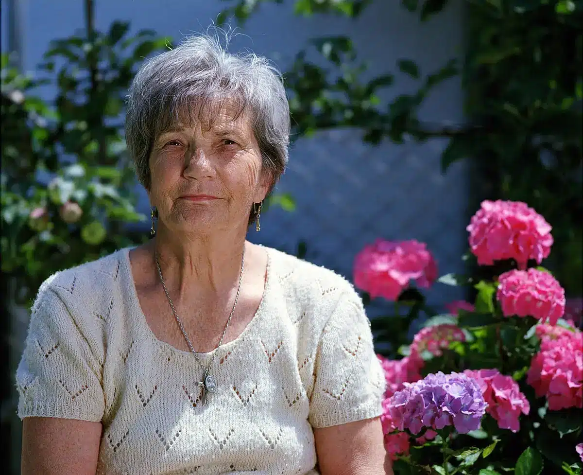 Older adult reviewing monthly bills and budget documents at home
