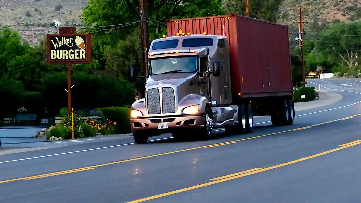 Cargo trucks at a border warehouse representing cross‑border supply chains