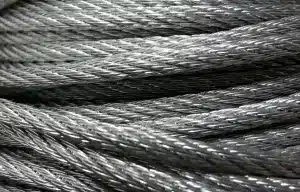Unbranded metal coils and pallets at a warehouse loading dock, silhouetted truck in background