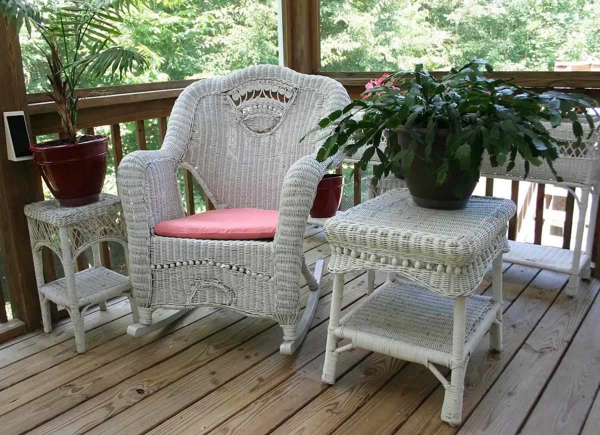 Empty porch with a rocking chair and potted plants implying stable retirement living