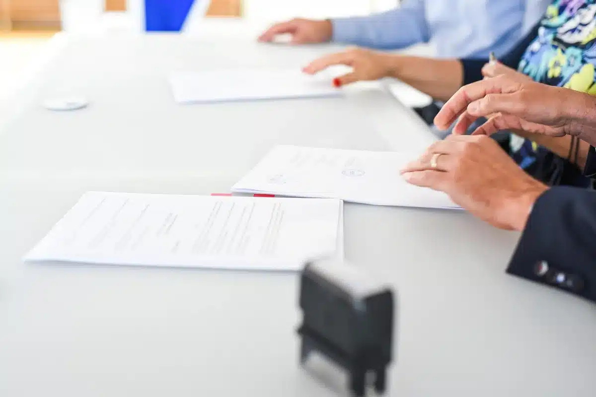 Couple reviewing mortgage paperwork at a kitchen table