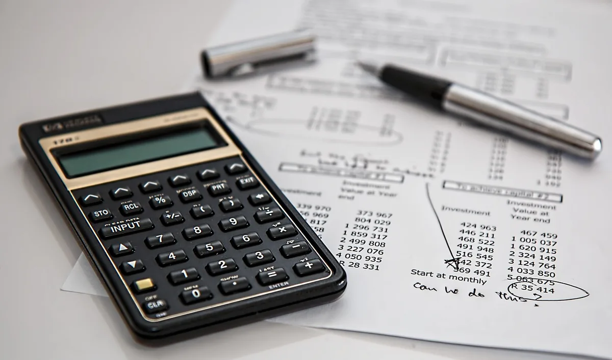 Close-up of a calculator and college tuition bill on a table