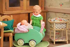 Two hands holding separate house keys above a table with paperwork and a toy, suggesting separation