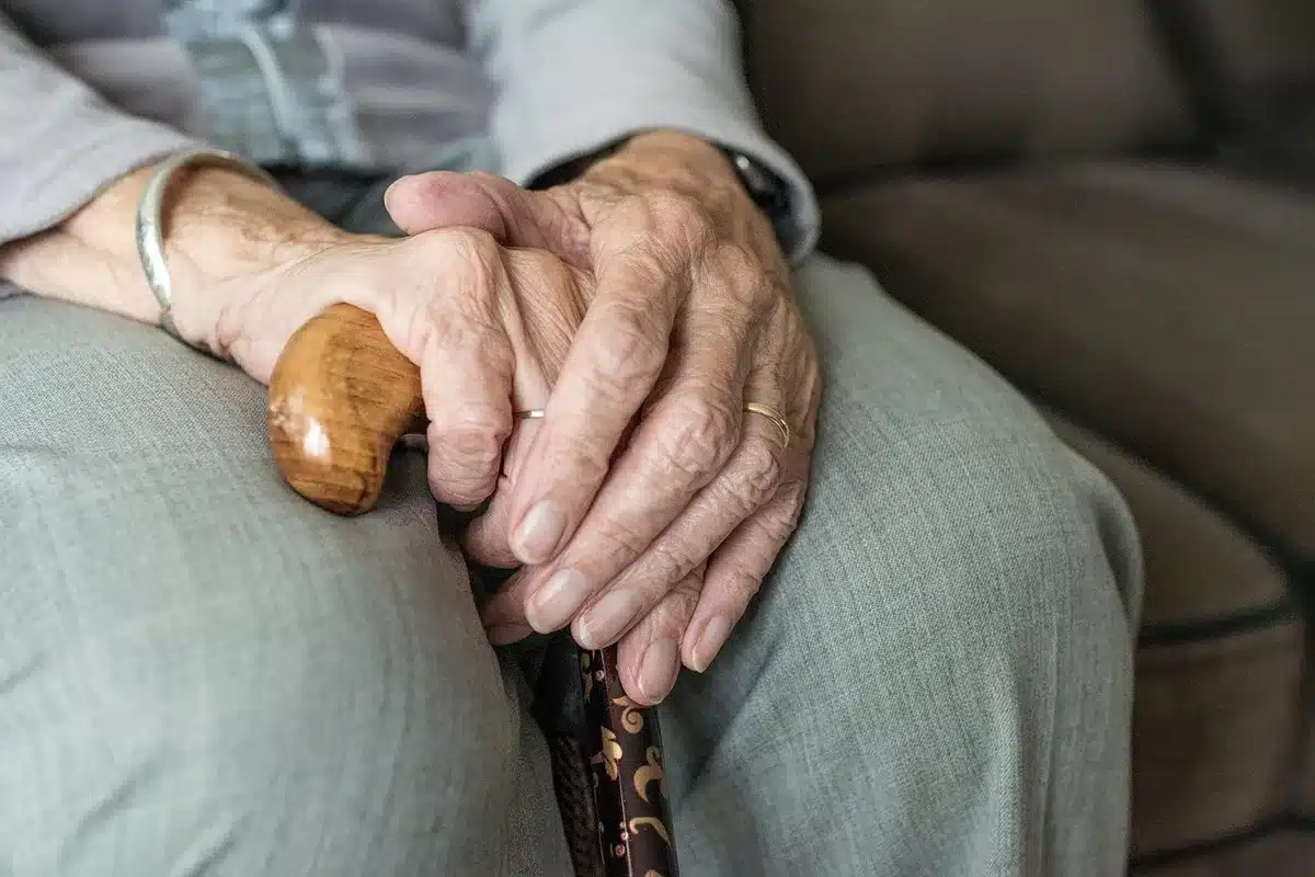 Person looking at retirement account statement while holding a pen