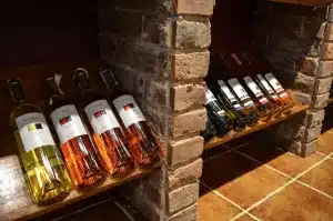 Empty winery cellar with stacked wooden cases and forklifts, suggesting a recent removal