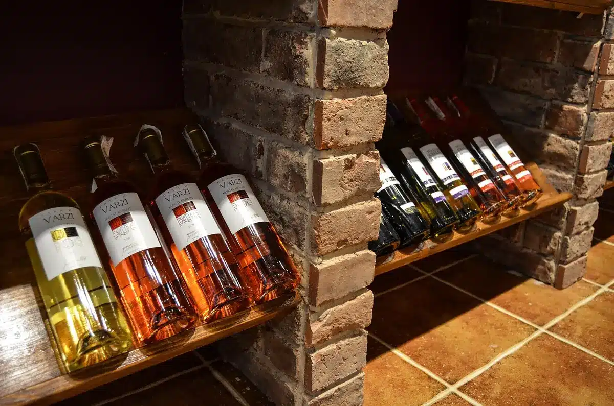 Empty winery cellar with stacked wooden cases and forklifts, suggesting a recent removal