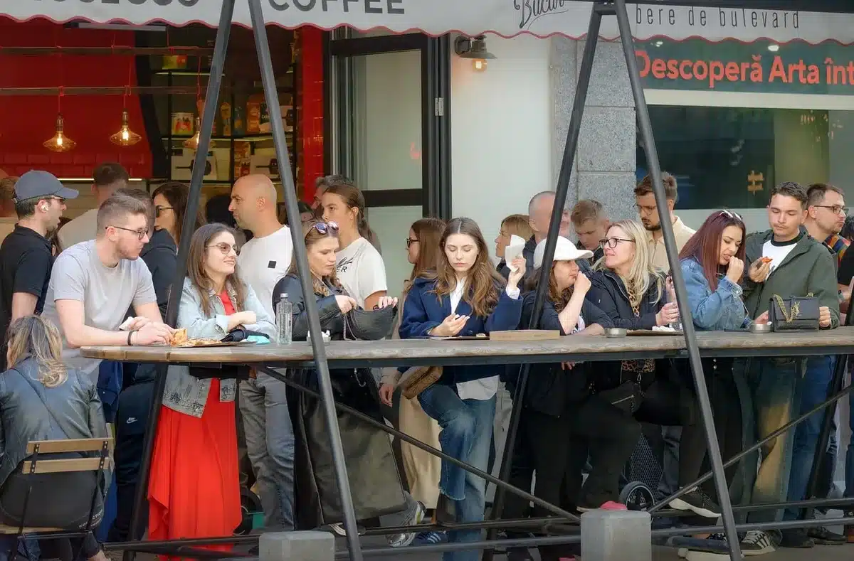 Anonymous crowd with signs and smartphones in an urban setting