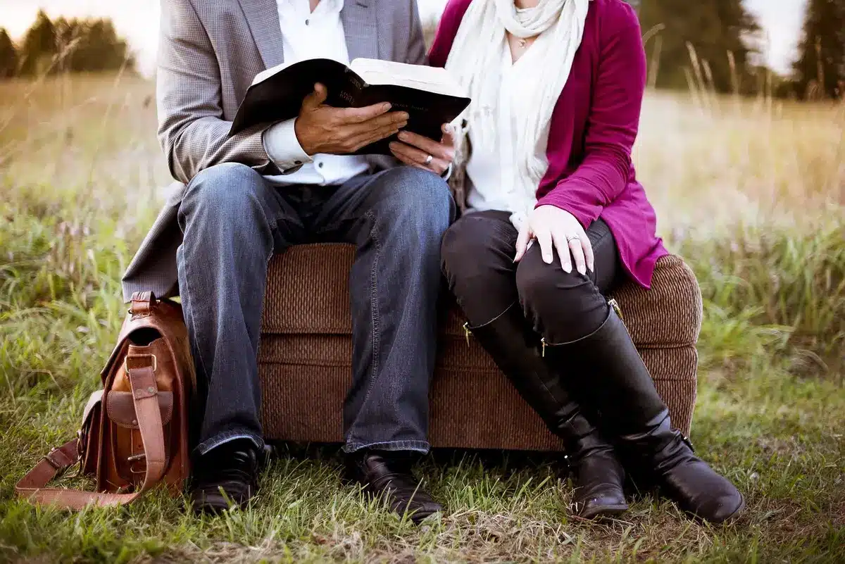 Couple sitting apart on a couch looking distant, showing strained intimacy