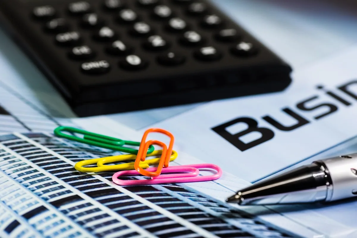 Senior reviewing projected monthly benefits with calculator and chart