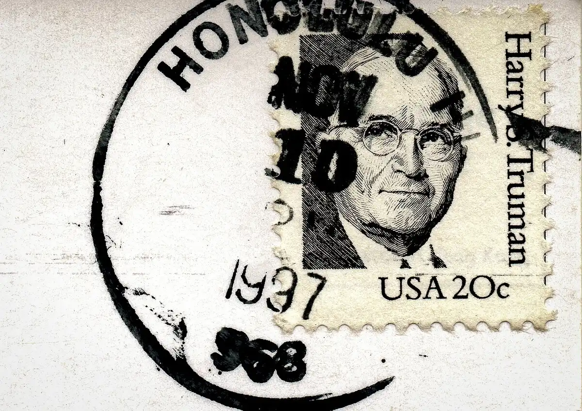 Close-up of an envelope being stamped with a postmark